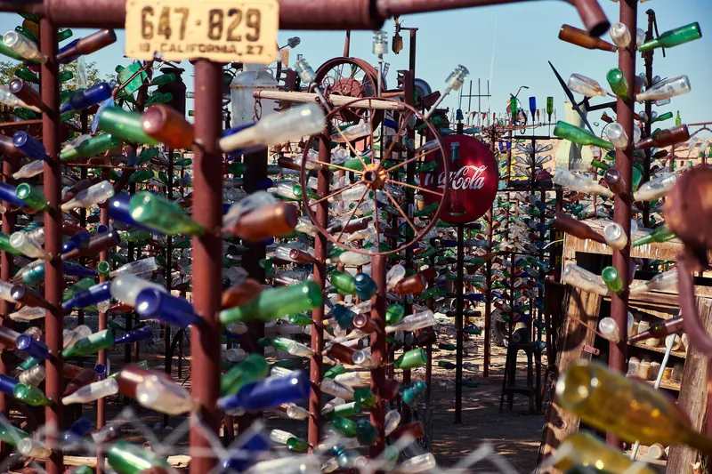Colored glass bottles on metal poles at Elmer's Bottle Tree Ranch on Route 66 in Oro Grande